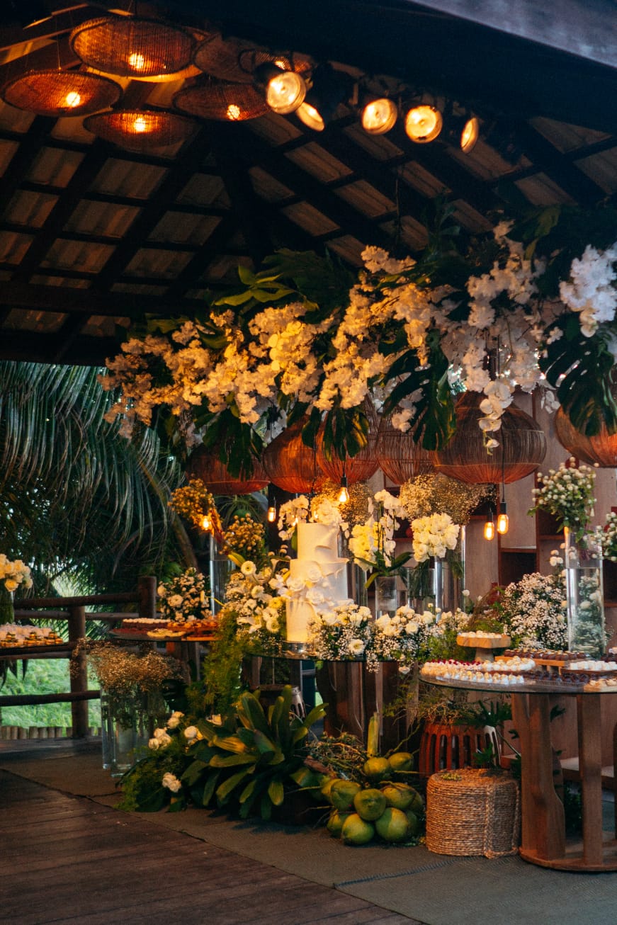 Mesa de doces luxuosa com decoração floral tropical em Salvador